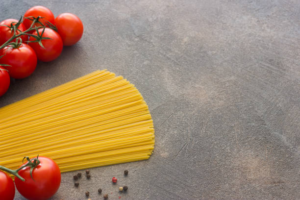 istock Ingredients for cooking Italian spaghetti on a dark background Top view 1222348134