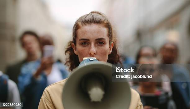 Female Activist Protesting With Megaphone During A Strike Stock Photo - Download Image Now