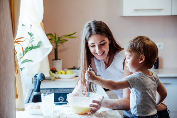 istock mother and young son prepare pie in the kitchen 1222350386