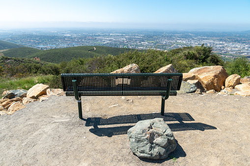 Resting area with bench on the top of the Double Peak Park in San Marcos. 200 acre park featuring a play area and hiking trails that lead to a summit.