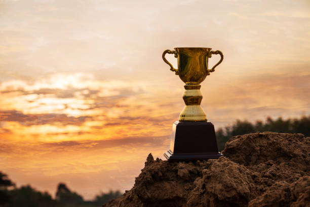 istock Gold trophy cup on top mountain with sunrise sky. 1222355552