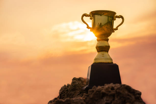 istock Gold trophy cup on top mountain with sunrise sky. 1222355554