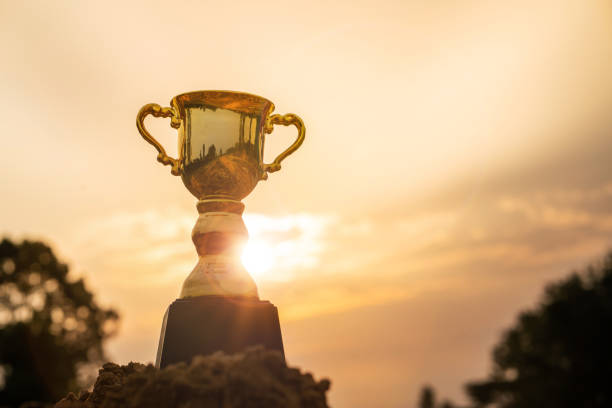 istock Gold trophy cup on top mountain with sunrise sky. 1222355555
