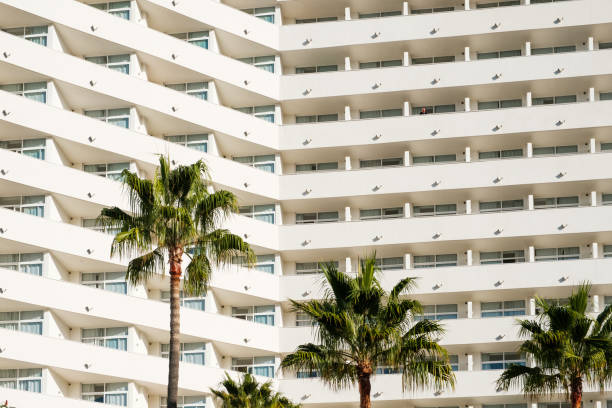 istock facade  hotel or apartment building palm trees 1222355656