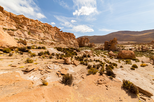 Eroded and bizarre formed orange colored rocks and boulders in Valle de Rocas, or Stone Valley, in the desert of southern Bolivia