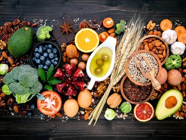 Photo of Ingredients for the healthy foods selection. The concept of healthy food set up on wooden background.
