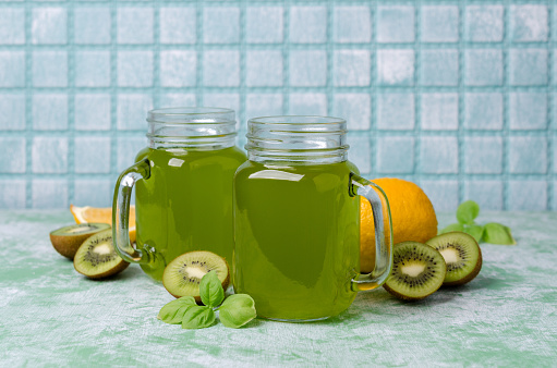 Kiwi drink in glass on a wooden background. Selective focus.