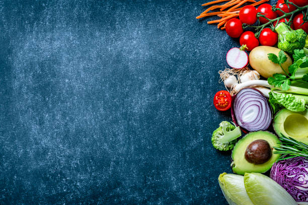 istock Vegan food: healthy fresh vegetables border. Copy space 1222364296