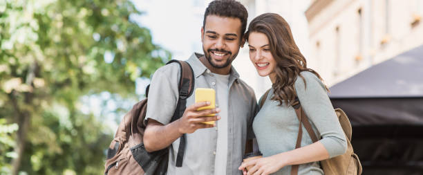istock Young couple using smartphone outdoors 1222365256