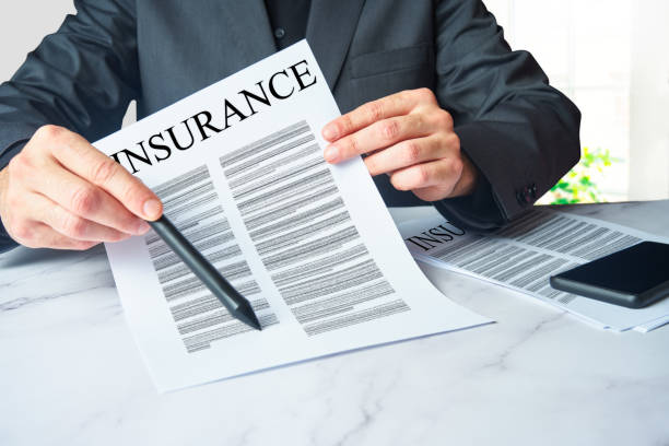 Insurance agent showing a contract to sign. stock photo