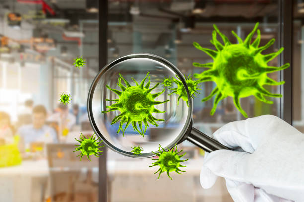 istock Coronavirus 2019.3D simulation of viruses inside the air by showing through a magnifying glass,Checking virus in office workplace. 1222368641