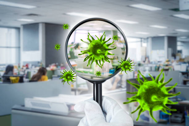 istock Coronavirus 2019.3D simulation of viruses inside the air by showing through a magnifying glass,Checking virus in office workplace. 1222368642