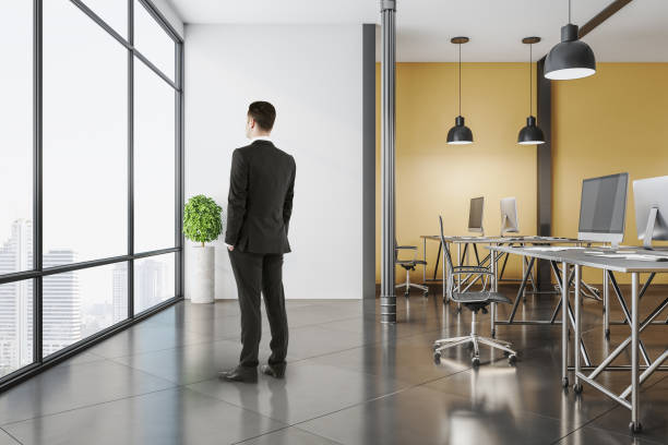 istock Businessman standing in modern coworking office 1222371692