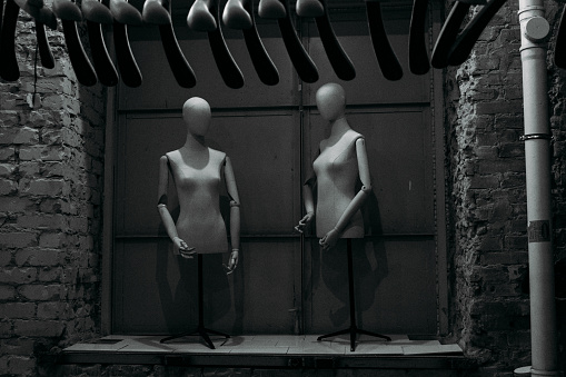 two black and white mannequins in the corner of the store