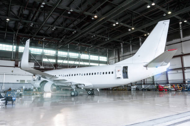 istock White airplane in the hangar. Passenger aircraft under maintenance. Checking mechanical systems for flight operations 1222373136