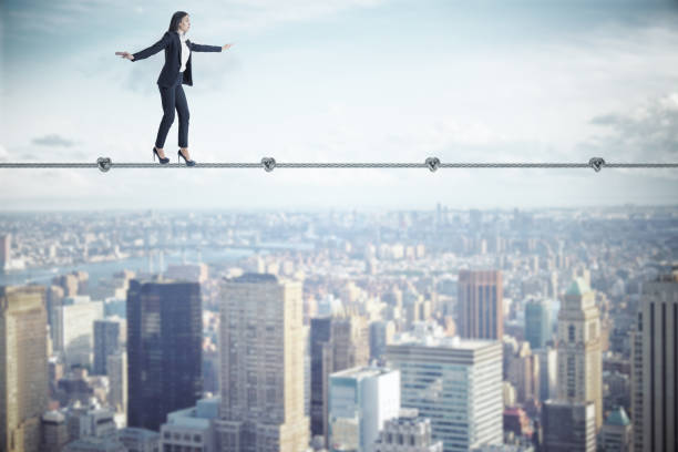 istock Businesswoman walking on rope 1222373505