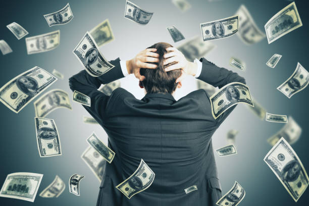 istock Depressive businessman and falling dollar banknote 1222373608
