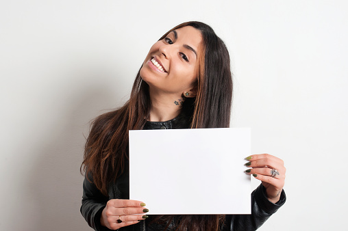 beautiful smiling brunette girl with placard, on white background