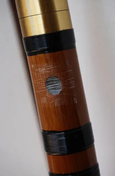 Closeup of chinese bamboo dizi flute with dimo membrane applied to mokong hole
