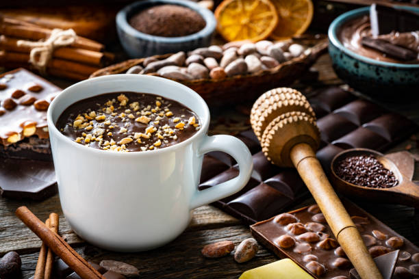 istock Melted chocolate cup and cocoa beans and pod with assorted chocolate 1222376415