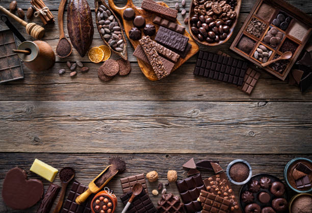 istock Assorted chocolate products with bars cocoa beans nuts spices rustic 1222377074