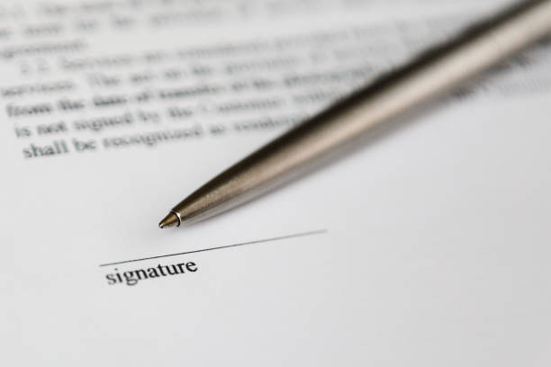 istock Space for signature on document and silver boll pen 1222378531