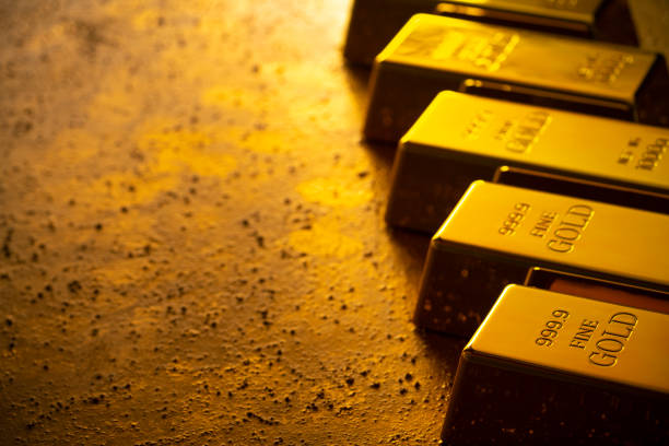 Gold bars financial concept in a row in golden background