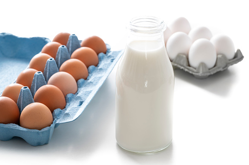 Dairy products milk with brown eggs and white eggs on white background