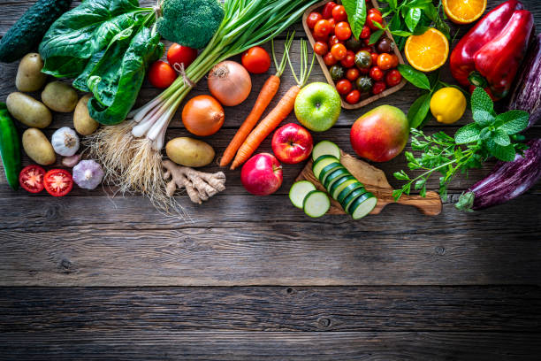 istock Fruits and vegetables vegetarian food on rustic wood board 1222380854