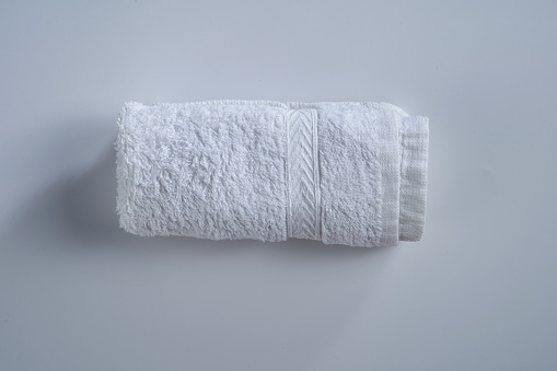 folded white hand towel on white background