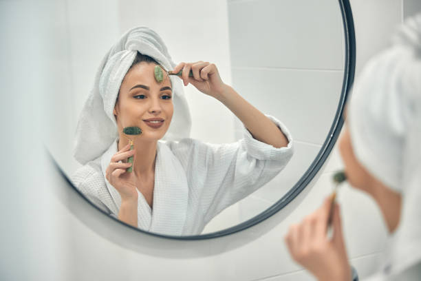 istock Caucasian smiling lady doing face massage in bathroom 1222384901