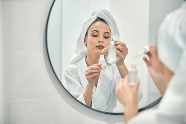 young attractive lady taking care of her facial beauty at home - sensuality lifestyles cheerful comfortable imagens e fotografias de stock
