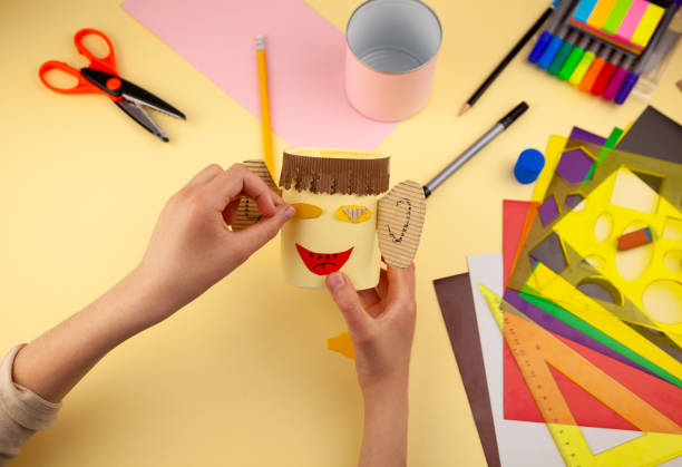 istock Step 21. Step-by-step instructions on how to make a stand for stationery from recycled materials. Do it yourself. A glass for pencils and pens from a plastic bottle and a can. A fun craft for kids DIY 1222386602