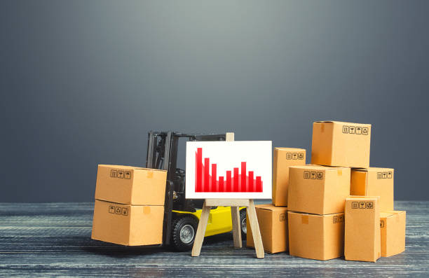 istock Forklift near boxes and easel red negative trend chart. Decline in production, low sales due to adverse bad economic trends shocks and disasters. Price reduction. Low competitiveness of goods 1222386901