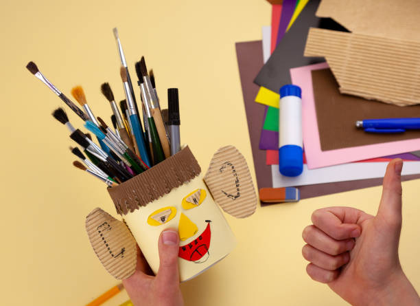 istock Step 29. Step-by-step instructions on how to make a stand for stationery from recycled materials. Do it yourself. A glass for pencils and pens from a plastic bottle and a can. A fun craft for kids DIY 1222387642
