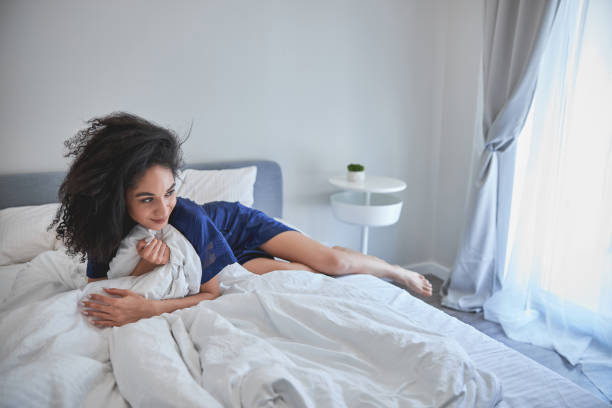 istock Pleased brunette woman lying on the bed 1222387792