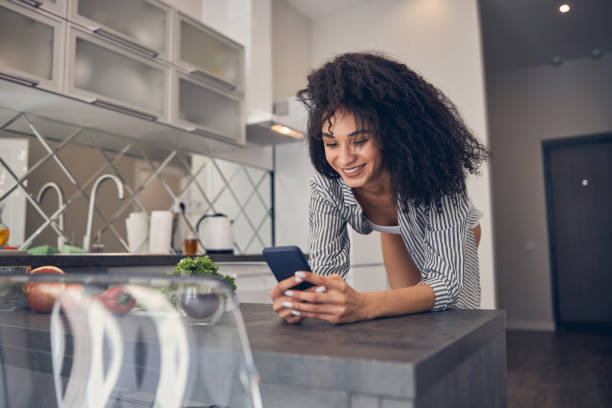 istock Smiling pretty girl reading a text message 1222387900