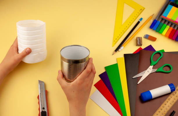 istock Step 4. Step-by-step instructions on how to make a stand for stationery from recycled materials. Do it yourself. A glass for pencils and pens from a plastic bottle and a can. A fun craft for kids DIY 1222388042