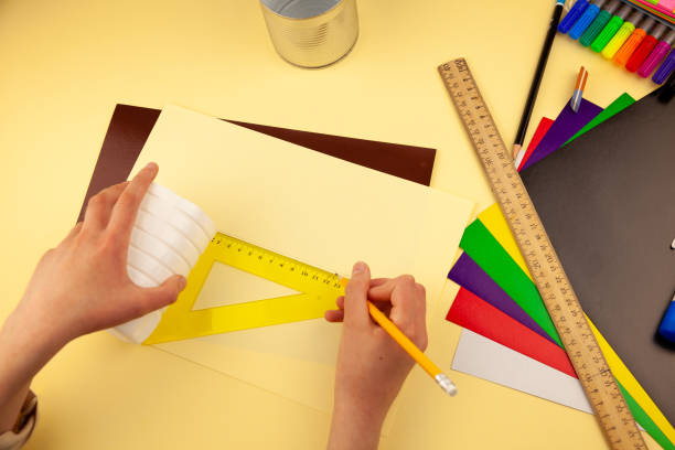 istock Step 5. Step-by-step instructions on how to make a stand for stationery from recycled materials. Do it yourself. A glass for pencils and pens from a plastic bottle and a can. A fun craft for kids DIY 1222388119