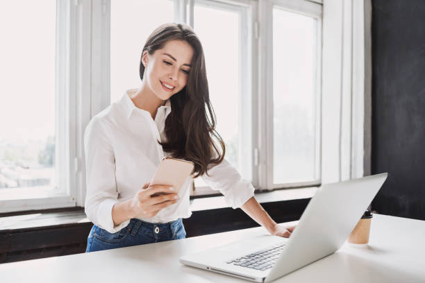 istock Business woman using laptop and smartphone 1222388340