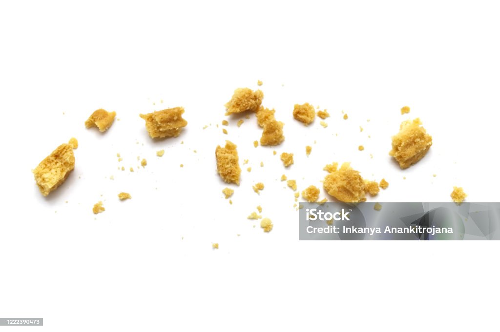 Scattered crumbs of butter cookies on white background. Crumb Stock Photo