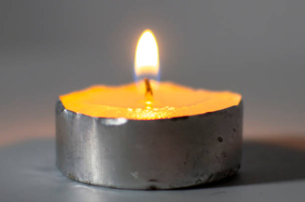 istock A wax lamp burns brightly on the white surface 1222391878