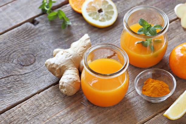 ginger shot with citrus fruits juice, turmeric and honey. - healthy drink imagens e fotografias de stock