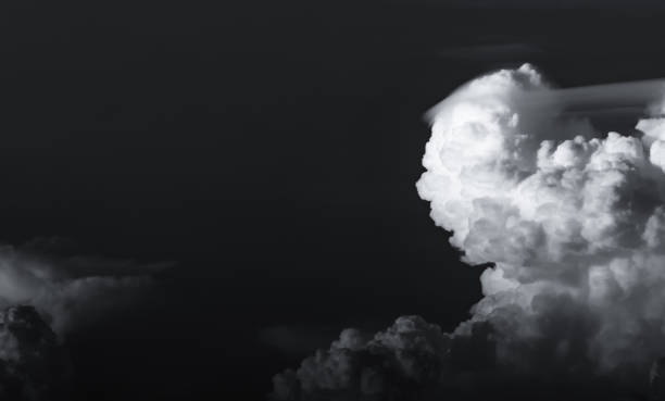 istock Dark dramatic sky and clouds. Background for death and sad concept. Black sky and white fluffy clouds. Sad and moody sky. Beauty in nature. Dead abstract background. Beautiful pattern of clouds. 1222391955
