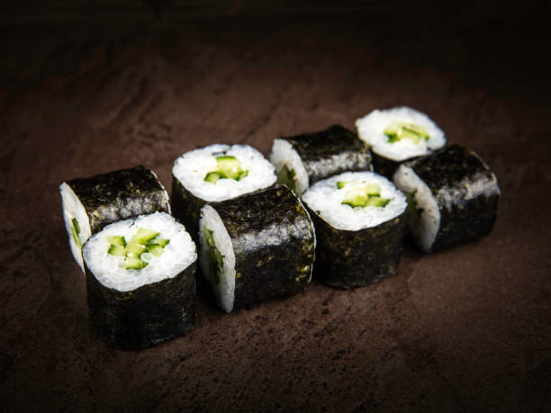 istock Japanese-style vegetarian rolls on a dark stone slab 1222392141