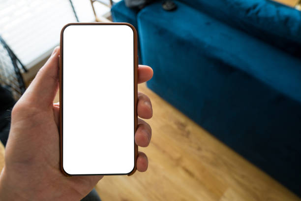 istock Working on mobile. Taking a picture. Phone in hand with white screen. Blur background. Mockup for mobile design. Close up. 1222392344