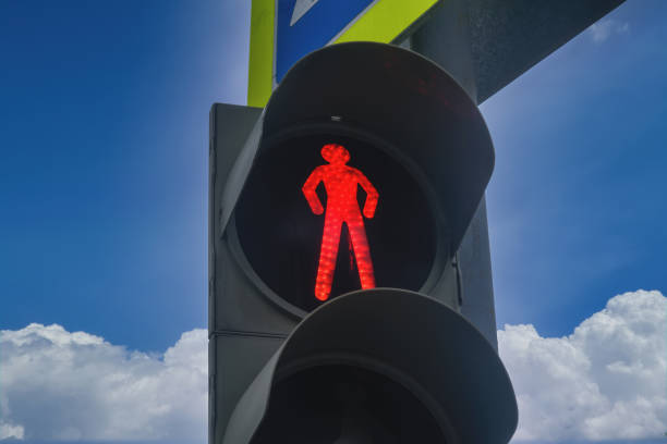 istock Traffic light with a burning red light on a background of cloudy blue sky. 1222394711