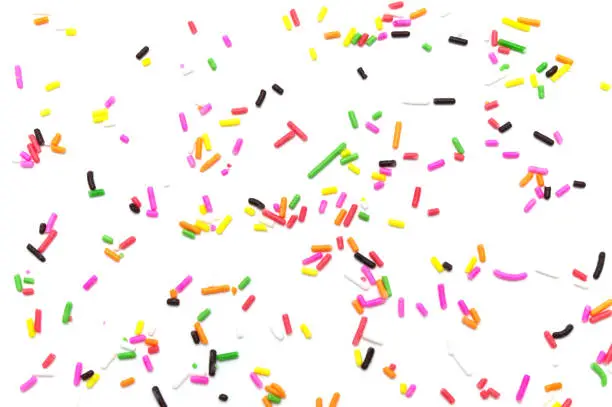 Photo of Colorful sprinkles sugar decoration for topping cake and bakery on white background.