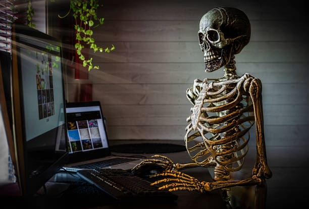 Human skeleton at office Skeleton at office desk, worked to hard. Spooky feeling.

Images on computers in the picture i my own, those are at my website. ergonomic keyboard photos stock pictures, royalty-free photos & images