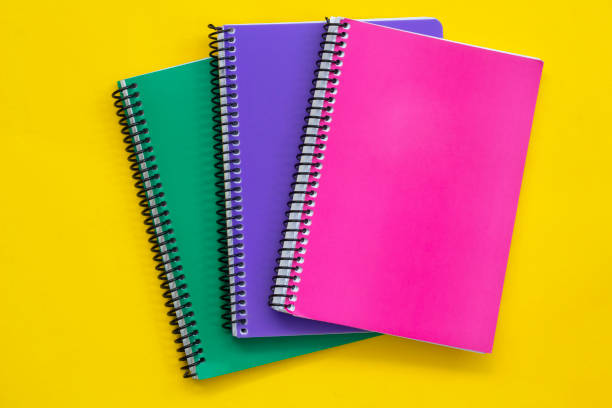 istock Colorful notebooks on a yellow background. Back to school concept. 1222399737